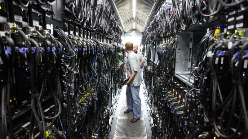 Image of a data centre serveer room showing a vast network of cable connections