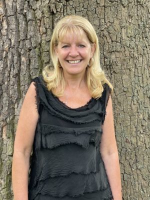 Pamela standing in front of a tree